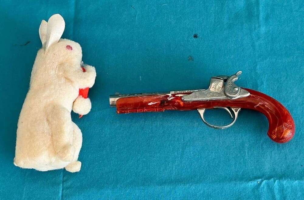 VTG 1950s Hubley Flintlock Jr. toy cap gun w/small stuffed toy rabbit.